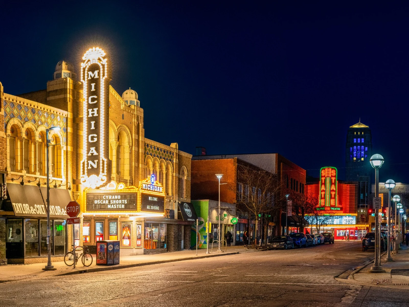 Downtown Ann Arbor at Liberty and State Street with an illuminated theater sign at night